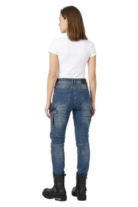 Person wearing blue cargo pants with a white background