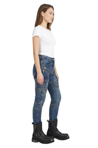 Woman wearing blue jeans and black boots on a white background
