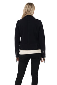 Person wearing a black jacket with a white shirt underneath on a white background