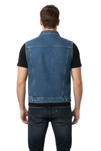 Man wearing a blue denim vest over a black shirt on a white background