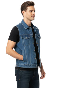 Man wearing a blue denim vest over a black shirt on a white background