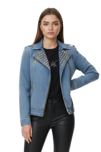 Woman wearing a blue denim jacket with studded details on a white background