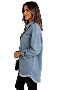 Woman wearing a light blue denim jacket on a white background