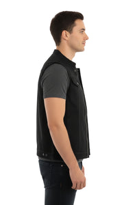 Man wearing a black vest over a gray shirt on a white background