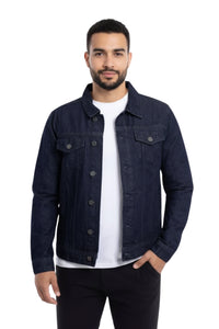 Man wearing a dark blue denim jacket over a white shirt on a white background