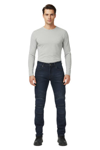 Man wearing a gray long-sleeve shirt and dark jeans on a white background