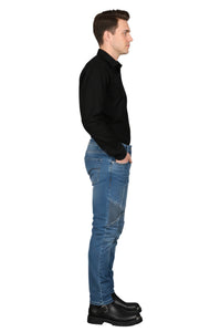 Man wearing a black shirt, blue jeans, and black shoes on a white background