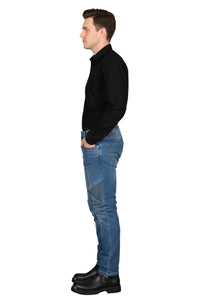 Man wearing a black shirt and blue jeans standing against a white background
