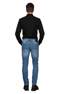 Person wearing a black shirt and blue jeans on a white background