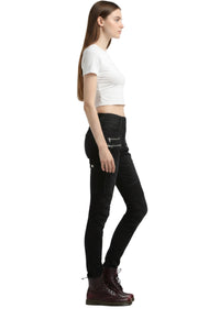 Woman wearing black jeans and a white crop top on a white background