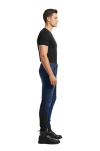 Man wearing blue jeans and black shoes on a white background