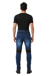 Person wearing blue jeans with black accents on a white background