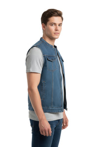 Man wearing a blue denim vest over a gray shirt on a white background