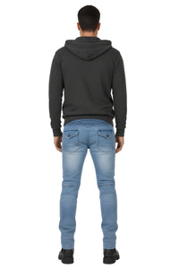Person wearing a black hoodie and light blue jeans on a white background