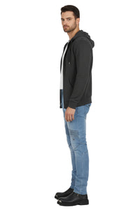Man wearing a black hoodie and light blue jeans on a white background
