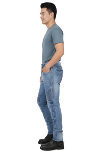 Man wearing light blue jeans and a gray t-shirt on a white background