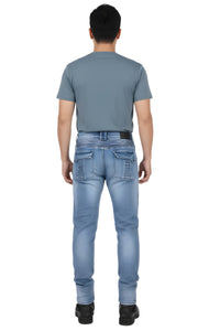 Man wearing a gray t-shirt and light blue jeans on a white background