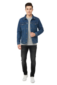 Man wearing a blue denim jacket over a gray shirt, black pants, and white sneakers on a white background
