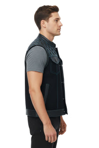 Man wearing a black vest over a gray shirt on a white background