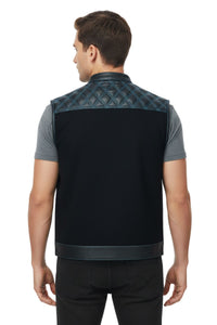 Man wearing a black quilted vest on a white background