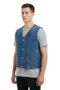 Man wearing a blue denim vest over a gray shirt on a white background