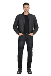 Man wearing a black jacket, black shirt, and black jeans on a white background
