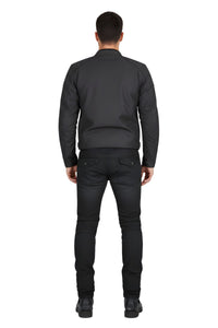 Person wearing a black jacket and pants on a white background
