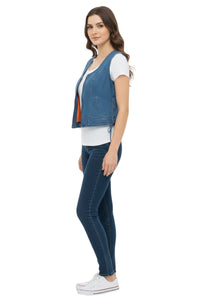 Woman wearing a denim vest and jeans on a white background