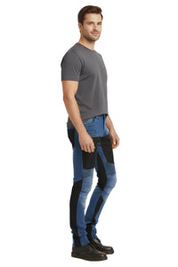 Man wearing a gray t-shirt and blue motorcycle pants on a white background