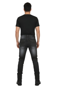 Person wearing black jeans and black shoes on a white background