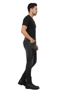Man wearing black t-shirt, gray pants, and black boots on a white background