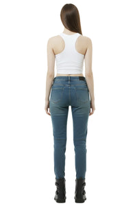 Person wearing blue jeans and a white tank top on a white background