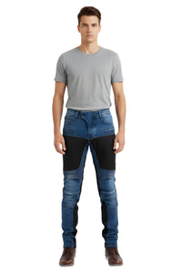Man wearing a gray t-shirt and blue jeans with black patches on a white background