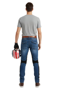 Man wearing blue jeans and a gray shirt, holding a helmet with a white background