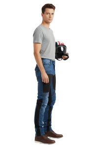 Man holding a chainsaw with protective gear on a white background
