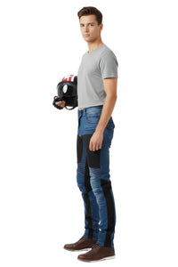 Man wearing protective overalls holding a chainsaw on a white background
