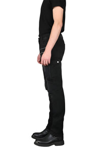 Person wearing black cargo pants and black shoes on a white background