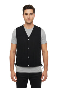 Man wearing a black vest over a gray shirt on a white background