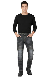 Man wearing a black long-sleeve shirt and gray jeans on a white background