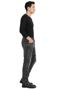 Man wearing a black long-sleeve shirt and gray jeans on a white background
