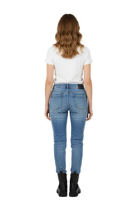 Person wearing blue jeans and a white shirt on a white background