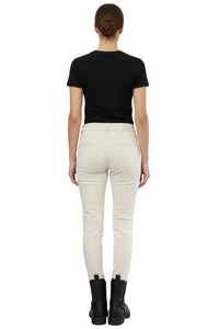 Person wearing a black t-shirt and white pants on a white background