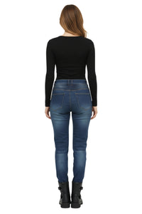 Person wearing blue jeans and a black top on a white background