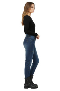 Woman wearing blue jeans and black boots on a white background