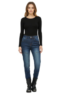Woman wearing a black long-sleeve top and blue jeans on a white background