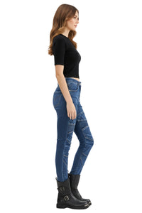 Woman wearing blue jeans and black boots on a white background