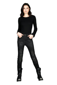 Woman wearing black top and black jeans on a white background