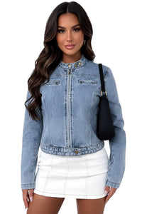 Woman wearing a denim jacket and white skirt with a black handbag on a white background